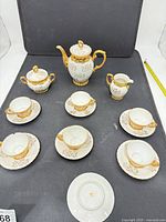 Full set arranged: coffeepot, sugar bowl, creamer, six cups and six saucers