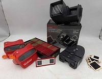 Group shot of all viewers, slide case, boxed Pana-Vue viewer, loose slides