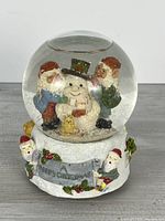 Full view of snow globe front showing snowman scene and base details