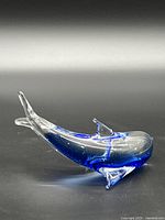 Left profile of blue and clear glass dolphin figurine