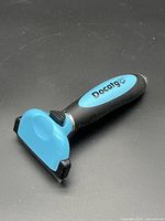 Full view of Docatg flea brush showing handle and comb