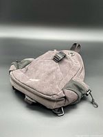 Front view of grey G4Free backpack showing compartments, buckle, mesh pockets