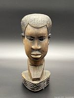 Front view of wooden male bust