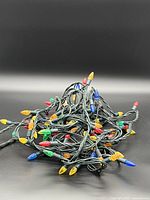 Full view of tangled string showing multicoloured bulbs on green wire