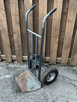 Full view of steel hand truck showing frame, toe plate and wheels