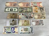 All 14 currency notes laid out front side visible