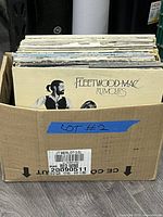 Box of LP records, front record Fleetwood Mac Rumours visible