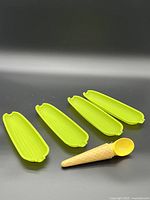 All four trays and novelty scoop on black background