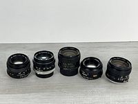 Group shot of five Minolta lenses front view