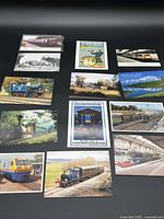 Group shot of all 13 railway postcards laid out face up