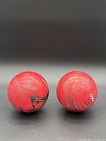 Front view of both marbled red bowling balls
