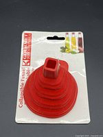Front view of red silicone collapsible funnel on retail card