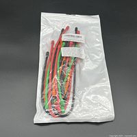 Front view of sealed package showing contents: coloured twist ties