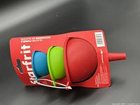 Front view of packaged Starfrit silicone funnels showing red, green, blue funnels