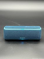 Front view of Sony SRS-XB21 speaker showing grille and logo