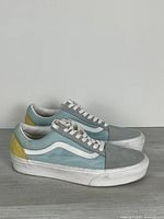 Left side view of both sneakers showing colour-blocked panels and condition