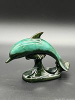 Left profile of glazed dolphin figurine