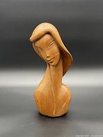 Front view of carved wooden female bust