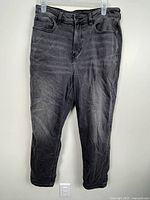 Front view of grey American Eagle jeans hanging
