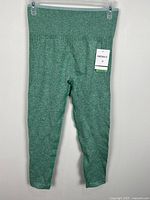 Full view of green cropped leggings hanging