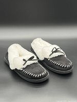 Top view of slippers showing faux fur lining and bow