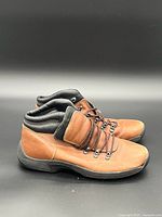 Left side view of both boots showing leather uppers, lacing, padded collar, outsole