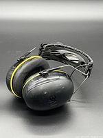 Side view of WorkTunes earmuffs showing ear cup, yellow trim and headband structure
