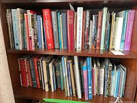 Two shelves of assorted books showing variety of subjects and formats