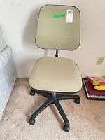 Front view of beige fabric office chair, seat and back visible
