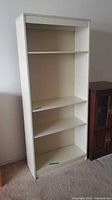Front view of white laminate bookcase, all shelves visible