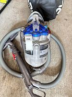 Top view of Dyson canister vacuum with hose and handle visible
