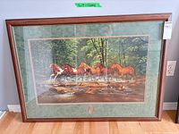 Full view of framed print on wall/floor showing frame, mat and image