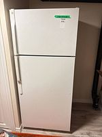 Front view of GE white top-freezer refrigerator