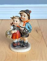 Front view of Hummel Goebel figurine showing children and basket