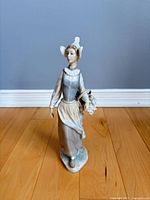 Front view of Lladró porcelain lady figurine holding basket