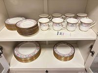 Full lot showing stacked plates and eight cups