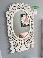 Front view of mirror showing entire carved frame and glass