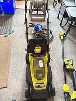 Top view of Ryobi 16 in ONE+ HP lawn mower with handle folded and battery cover closed