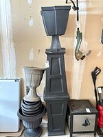 Tall black pedestal with square planter pot
