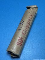 Worn brown paper coin roll marked 50¢ Coppers, handwritten 1938
