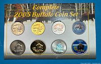 Front of display card showing all eight coins and title
