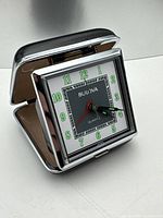 Clock standing open showing dial and faux leather lid