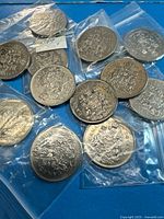 Overview of all 12 Canadian 50-cent coins in plastic sleeves