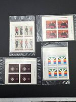 Four different inscription corner blocks in plastic sleeves