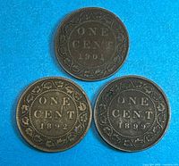 Group shot of three Canadian one-cent coins dated 1892, 1899, 1901