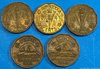 Reverse sides: three 1943 Victory and two 1942 beaver coins