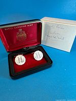 Cufflinks in open red satin presentation box with outer sleeve
