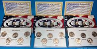 All three Platinum Edition quarter sets with certificates and boxes visible