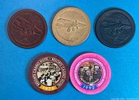All five casino chips arranged on blue background
