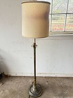 Full view of brass torchiere floor lamp with fabric drum shade